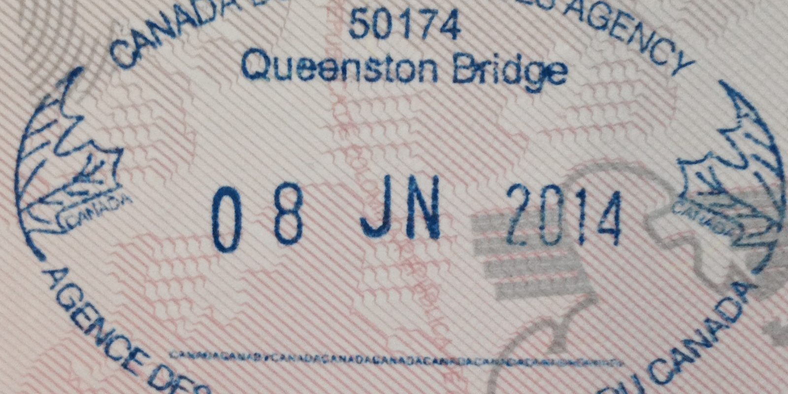 A border agency entry stamp in a passport