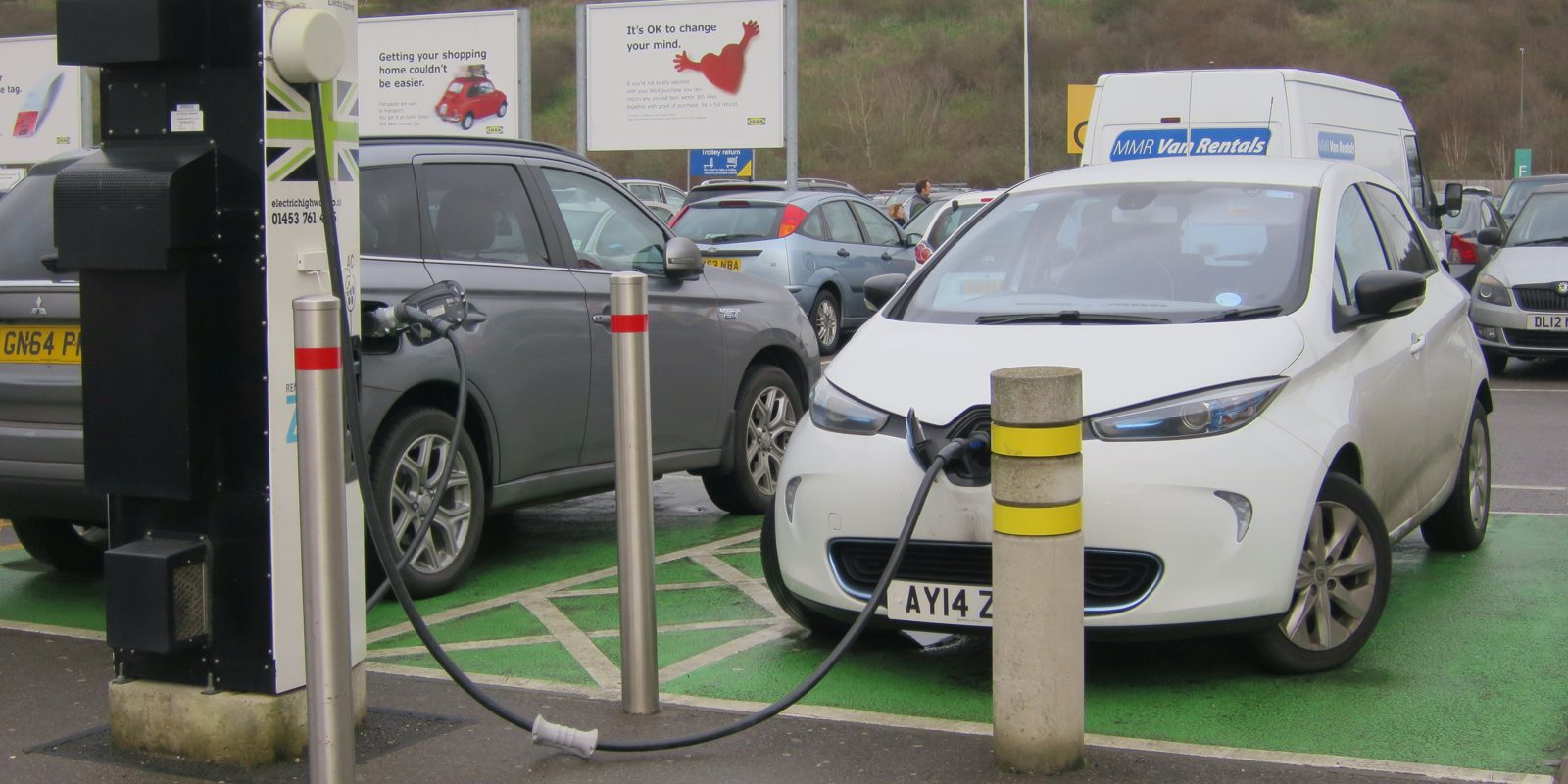 An electric car plugged in at a public charging point