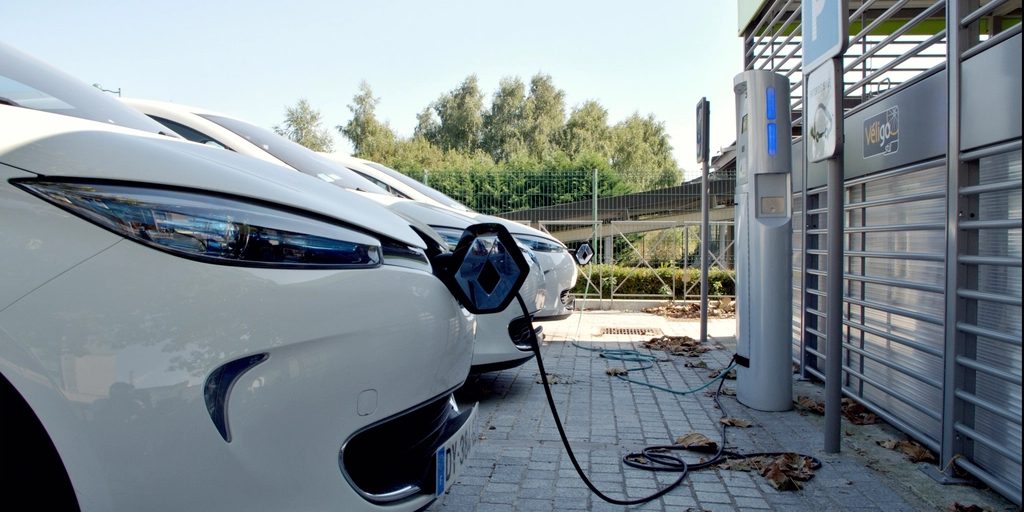 An electric car plugged in at a charging point