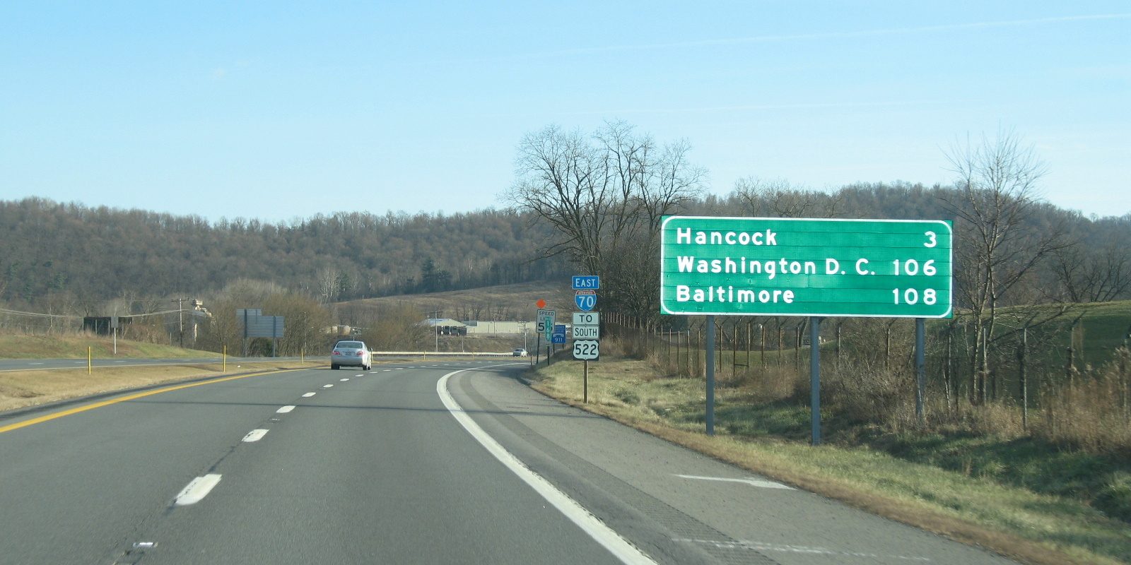 An American interstate with a green sign giving the distance in miles to Washington and Baltimore